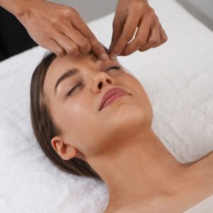 view-woman-getting-facial-yoga-massage-stay-young (1)